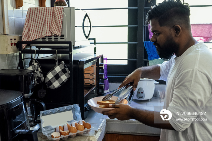 Couple making breakfast together at home in the morning