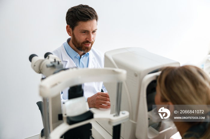 Optometrist checks the patient’s intraocular pressure in optician’s shop or ophthalmology clinic