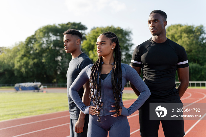 Portrait of group of athletes standing at stadium