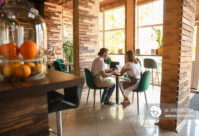 Business owners working at table in their cafe