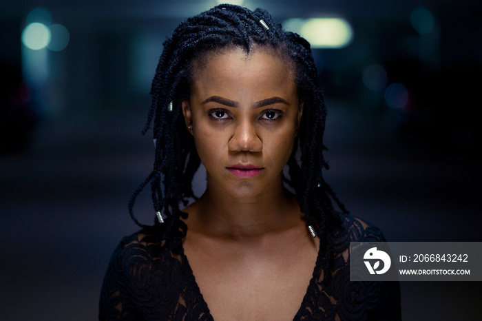 Night portrait of a stylish young African woman