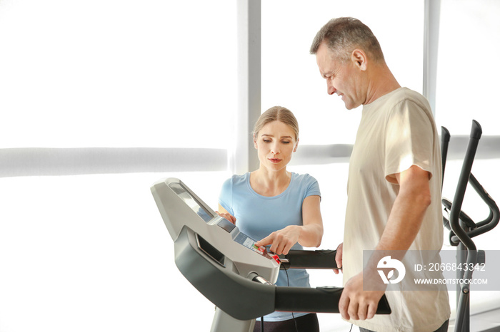 Physiotherapist working with mature patient in rehabilitation center