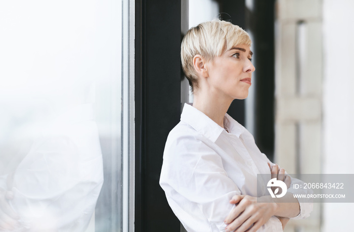 Anxious Entrepreneur Woman Thinking Standing Near Window In Modern Office