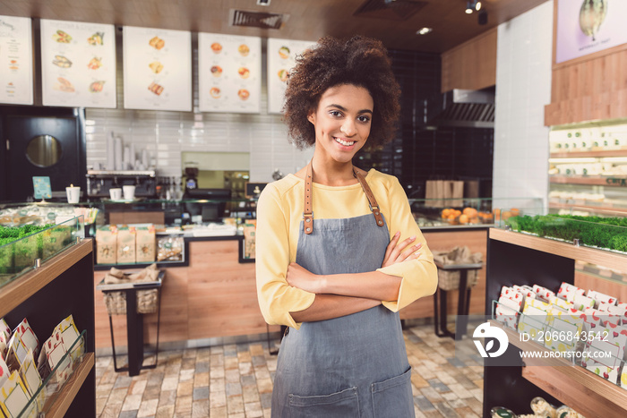 Delightful young woman is working in health food store