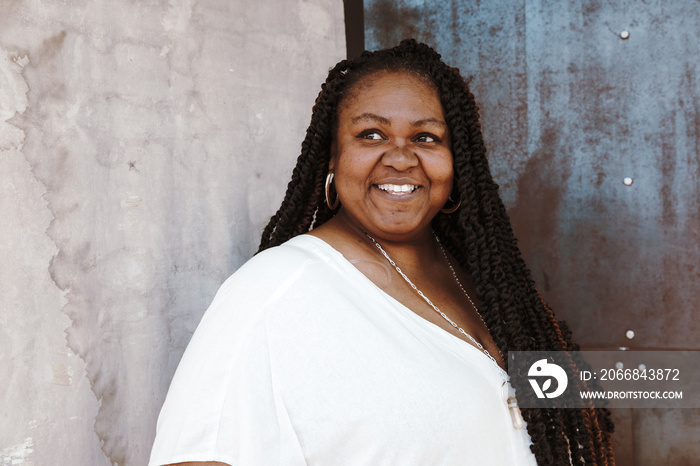 portrait of a plus size Afro Latinx Haitian American woman smiling and looking away