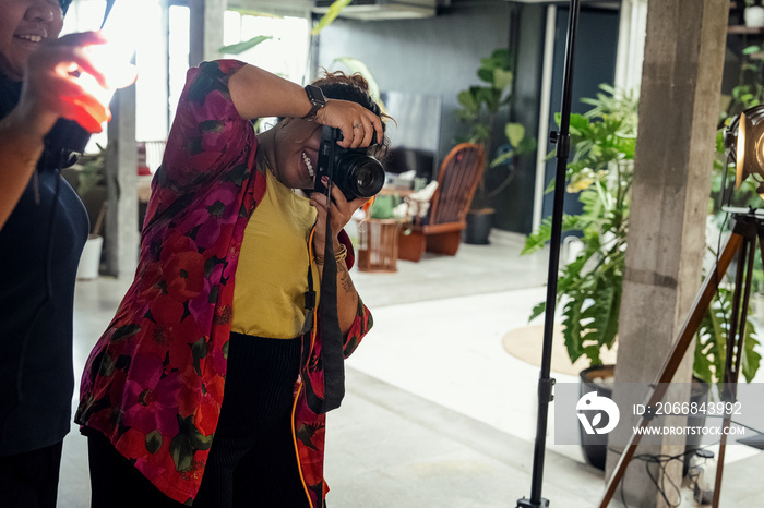 Plus sized female getting her headshots taken by a south asian female photographer