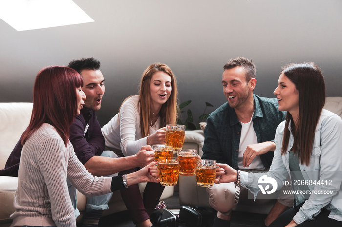 Happy group of friends drinking beer and eating pizza