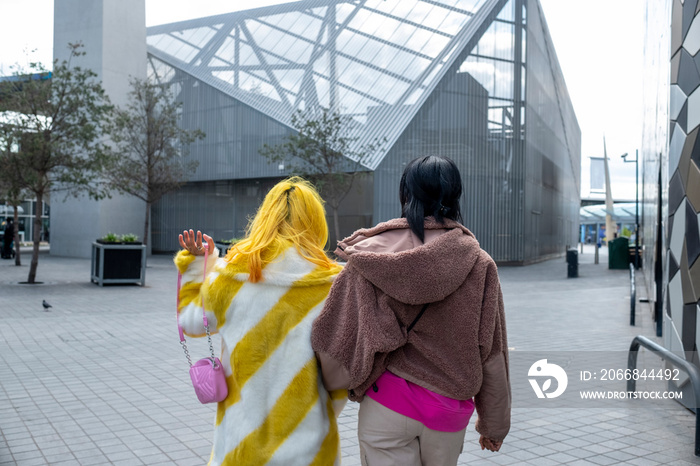 Stylish young friends walking outdoors