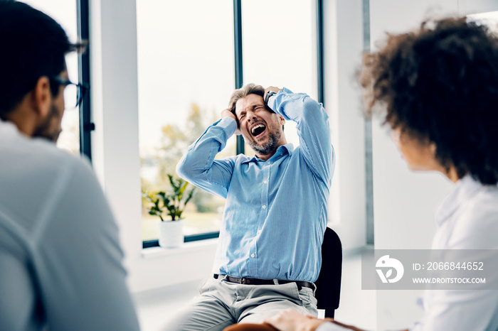 A man having mental burnout at support group.