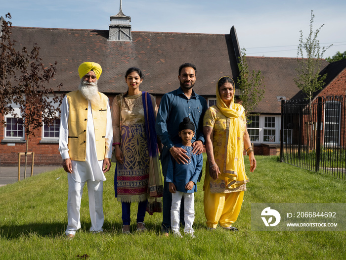 Portrait of three-generation family (6-7) in traditional clothing