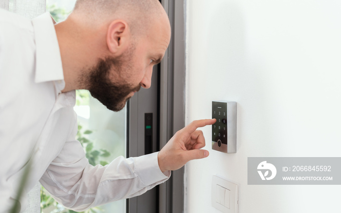 Man setting an alarm code for home security