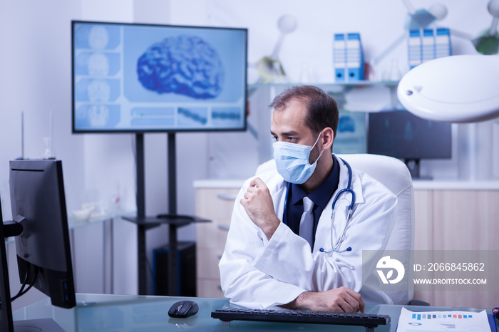 Concentrating doctor on his work at the cabing with his mout covered