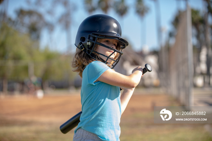 Boy kid holding a baseball bat. Pitcher child about to throw in youth baseball.