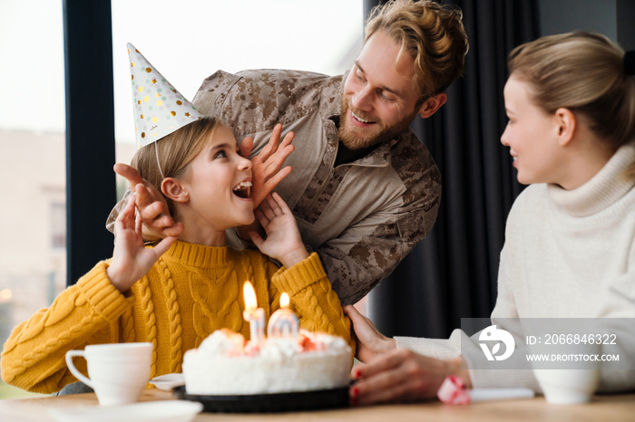 Beautiful happy family celebrating birthday of daughter at home