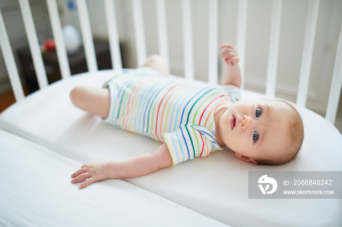 Baby girl in co-sleeper crib