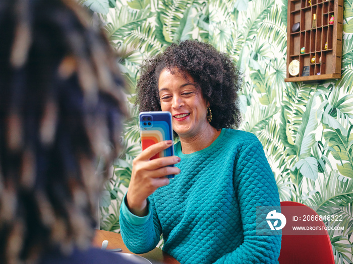 Woman taking picture of man with smart phone