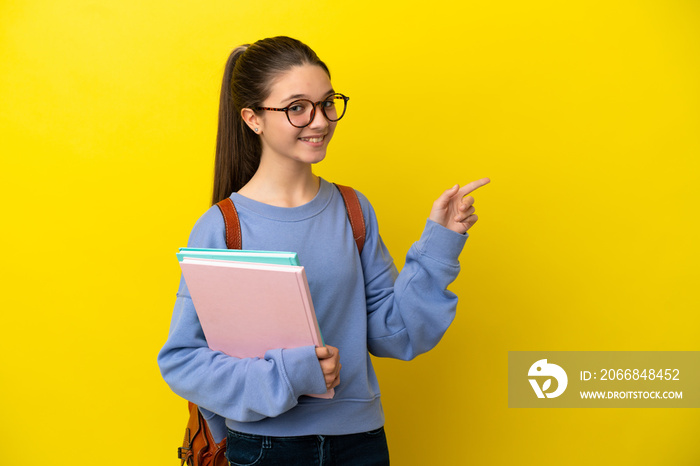 Student kid woman over isolated yellow background pointing finger to the side