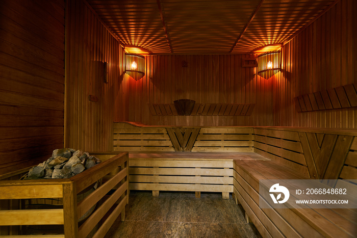 Wooden sauna interior. Relax in a hot small Finnish wooden sauna room in SPA centre