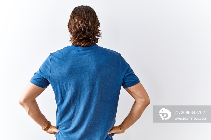 Handsome middle age man standing together over isolated background standing backwards looking away with arms on body