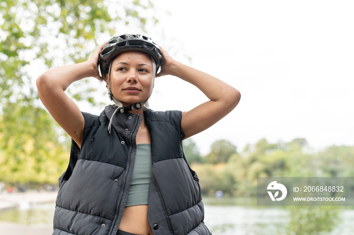 Woman wearing bike helmet in park