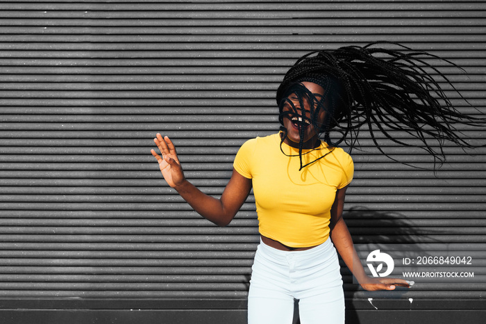 African american woman waving her dreadlocks