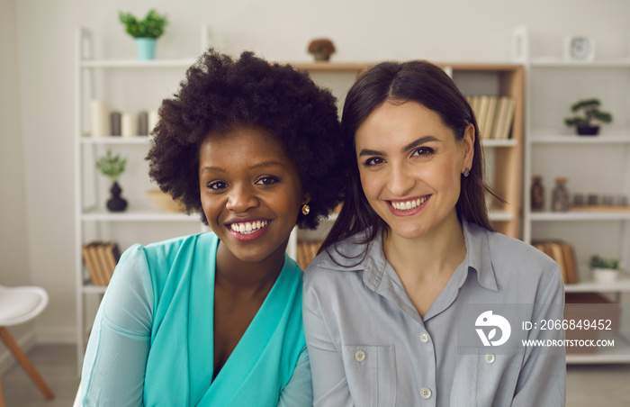 Friendly african american and caucasian coworker or students friends headshot portrait in office. Multiracial friendship, good quality racial diversity equality, equal opportunity in the workplace