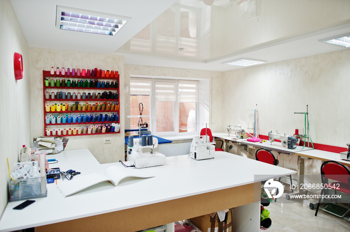 Workplace of seamstress office with sewing machine on table.