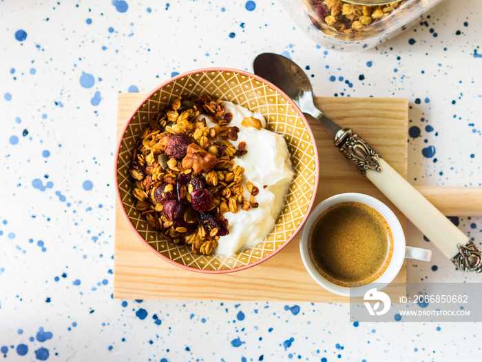 Home made granola bowl with greek yogurt for breakfast. Pumpkin pie granola with squash, dried fruit, seeds and nuts. Autumn mood