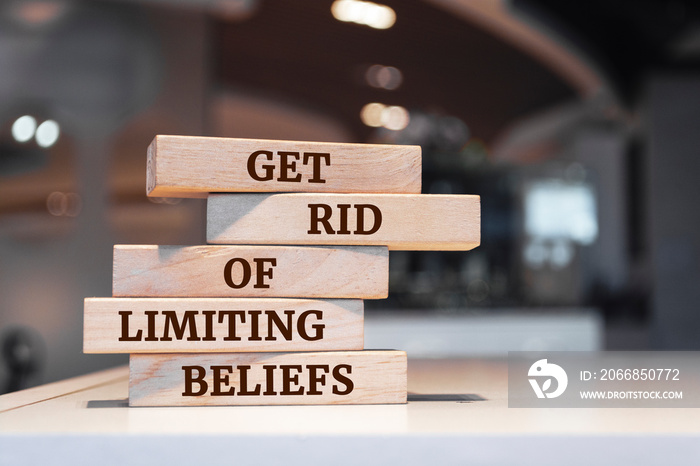 Wooden blocks with words ’Get Rid Of Limiting Beliefs’.