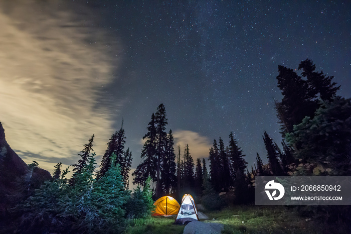 Tents glow under the stars in the woods near White Pine Lake in Utah.