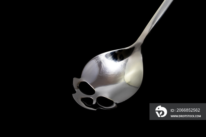 Metal spoon for sugar in the shape of skull