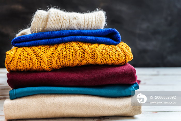 Stack of colorful warm autumn and winter clothes