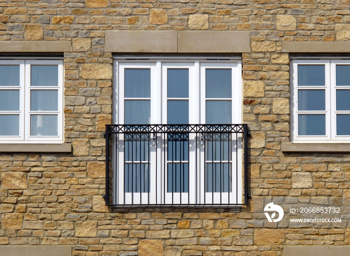 Contemporary Juliet Balcony and three windows in a stone wall