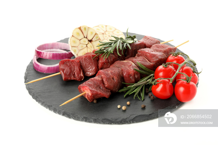 Board with raw shish kebab meat and vegetables isolated on white background