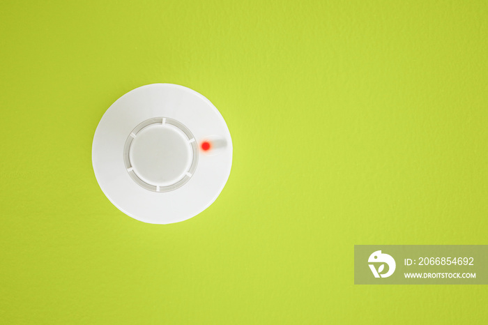 Smoke detector on yellow background. Security system.