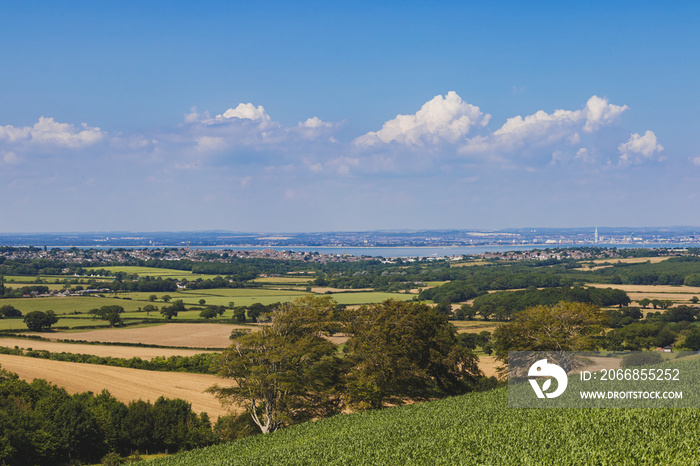 The view from Brading Down, Isle of Wight with the town of Ryde to the left and the city of Portsmouth across the Solent to the right.