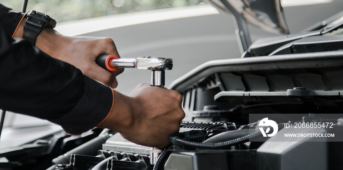 Mechanic fixing a car at home. Repair and service.