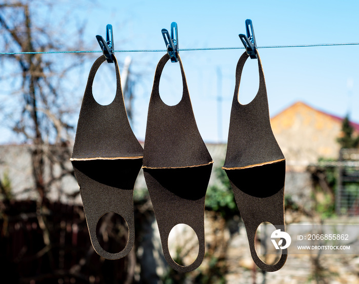 Reusable masks are dried on a clothesline in the open air