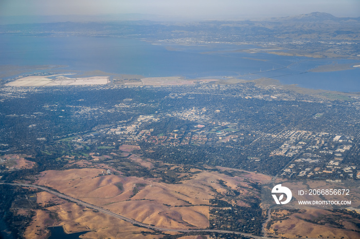 Aerial view of Silicon Valley towns (Palo Alto, Menlo Park, Redwood City); east bay and Mt Diablo in the background; San Francisco bay area, California