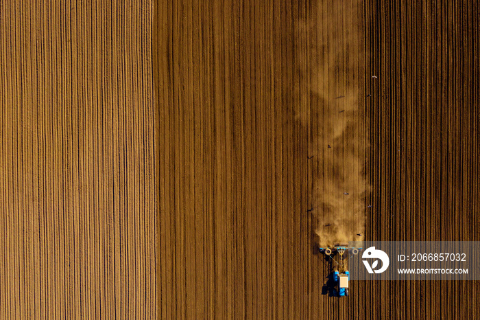 Tractor in field on a farm, aerial view