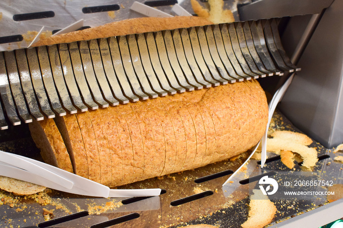 Bread slicer in a supermarket. Industrial bread slicer.