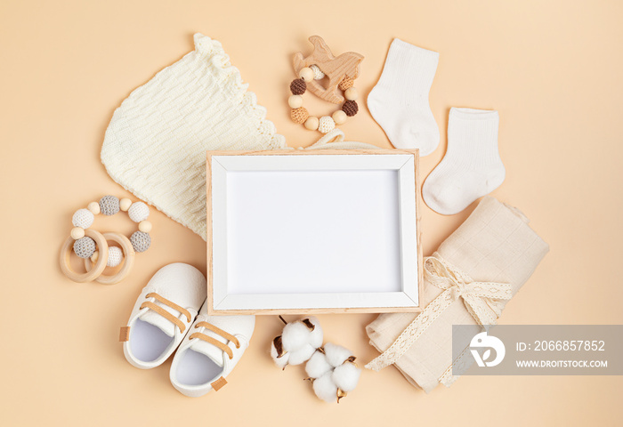 Mockup of empty frame with eco friendly baby accessories. Baby shower invitation, greeting card. Template for brand, logo, advertising. Flat lay, top view