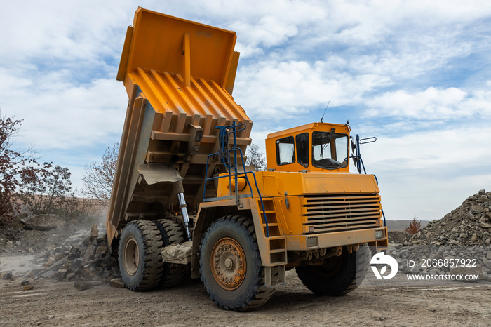 Large mining dump truck. Transport industry. Extraction of stone in an open pit