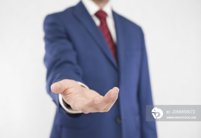 Businessman with open hand. Holding, giving, showing concept.