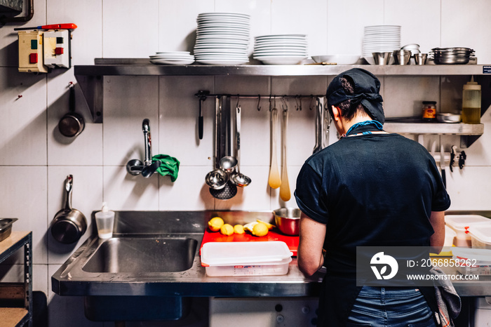 exploited immigrant cook working alone in a kitchen