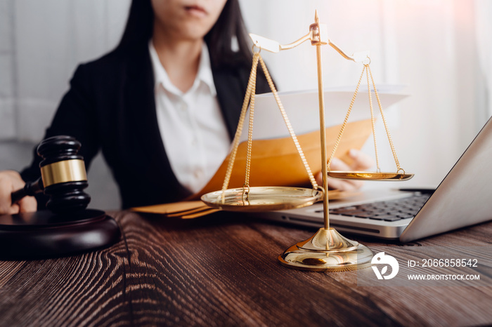 Justice and law concept.Male judge in a courtroom with the gavel, working with, computer and docking keyboard, eyeglasses, on table in morning light