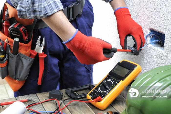 Young electrician technician works in compliance with safety standards in a residential electrical system.