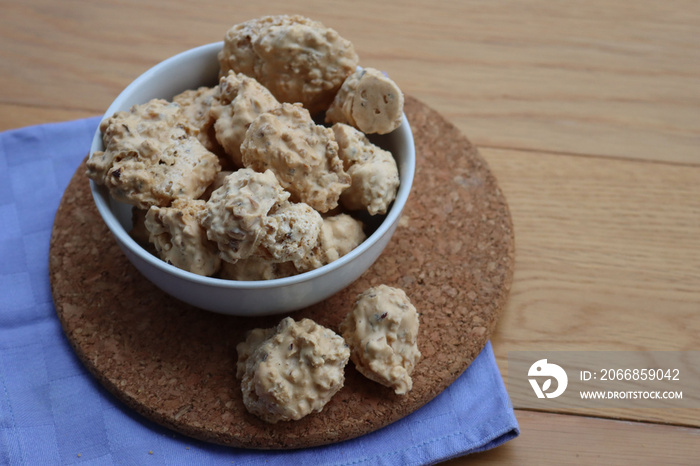 Traditional italian “Brutti ma buoni” ( Ugly but good) cookies made with hazelnut and honey in a bowl on wooden table