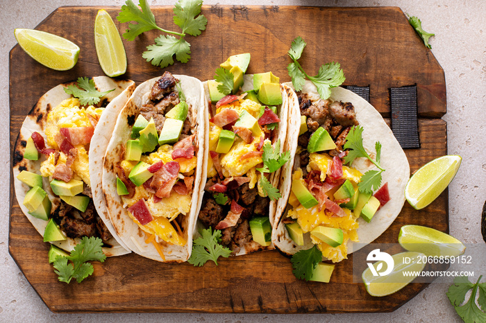 Breakfast tacos with sausage, eggs, bacon and avocado