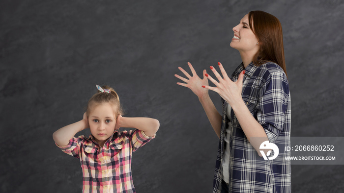 Furious mother arguing her little girl child